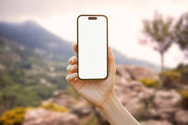 istock Young woman showing mobile phone blank white screen on Summer Background 2161774123