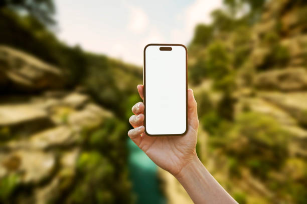istock Young woman showing mobile phone blank white screen on Summer Background 2161774133