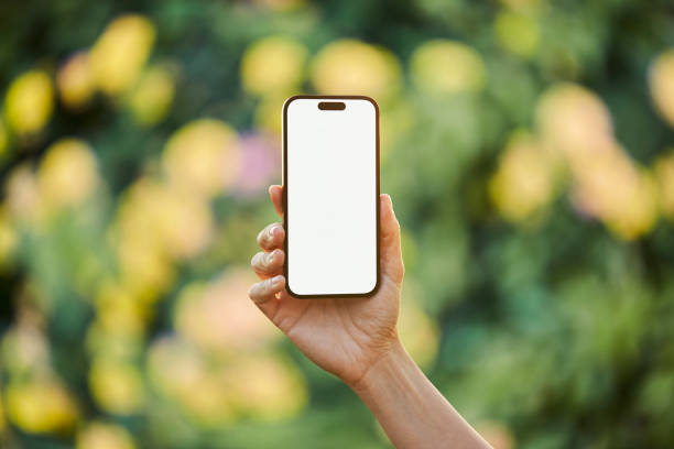 istock Young woman showing mobile phone blank white screen on Summer Background 2161774135