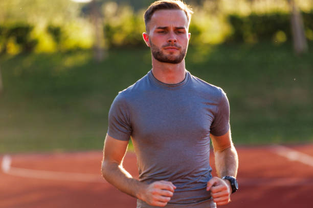 istock Young Man Jogging Outdoors 2161775360