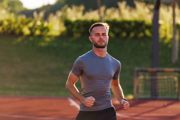 Young man jogging on running track