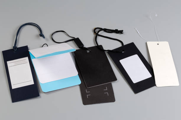 istock Several blank cardboard sale clothing swing tags on ropes 2161777583