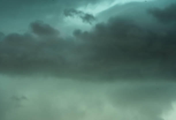 Gloomy sky filled with storm clouds that create an evocative atmosphere due to its cold blue-green coloring