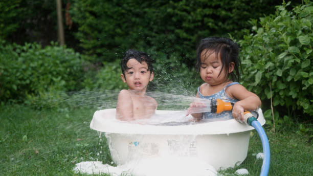 istock Happy Asian boy enjoy playing in the bathtub on backyard. 2161784675