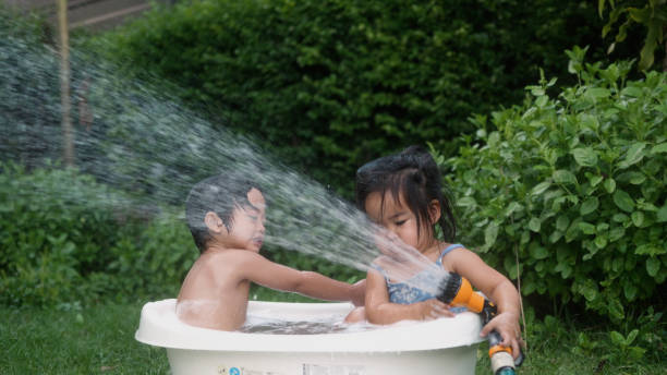Happy Asian boy enjoy playing in the bathtub.