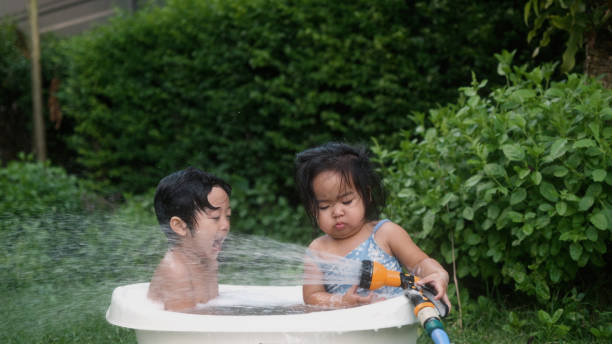 Happy Asian boy enjoy playing in the bathtub.