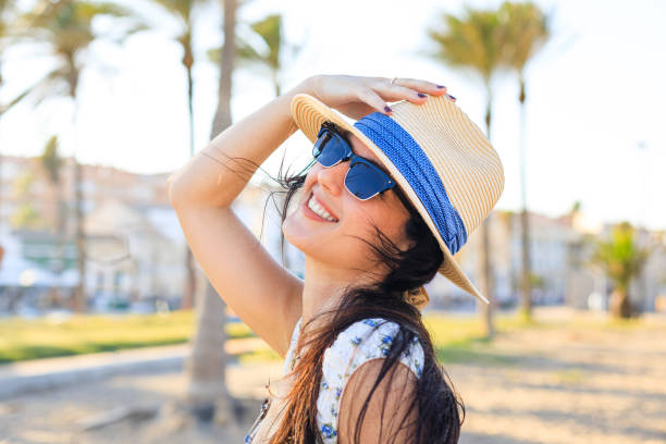 istock Smiling Girl in a Straw Hat at the Beach 2161784747