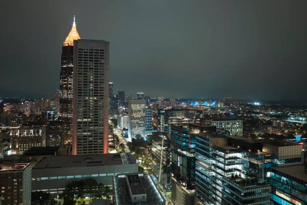 View from above of brightly illuminated high skyscraper buildings in downtown district of Atlanta city in Georgia, USA. American megapolis with business financial district at night.