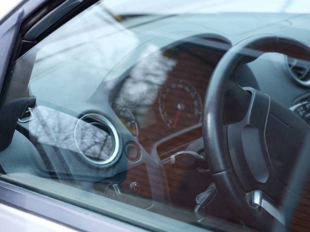 istock A shot of a car dashboard and steering wheel through a window 2161790690