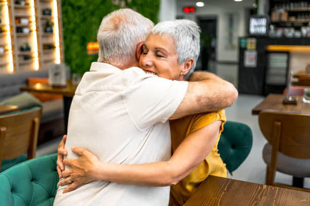 istock Senior couple embracing in a restaurant 2161791416