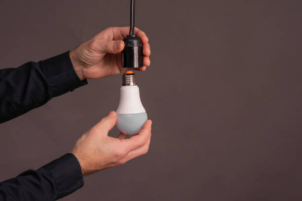 istock LED lamp in hand. copy space 2161793400