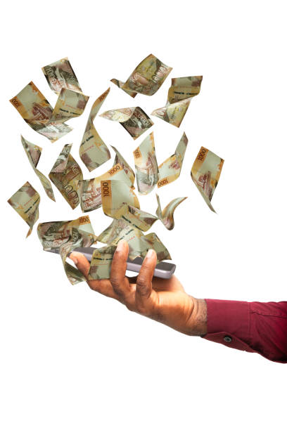 istock Black hand holding phone with kenyan shilling notes hovering on screen isolated on white background. 3d rendered banknotes 2161793752
