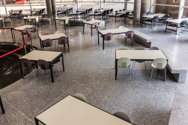 Interior view of a modern Bangkok university library. Empty learning stations stretch across the area.