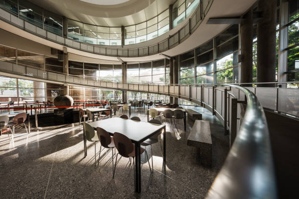Interior view of a modern Bangkok university library. Empty learning stations stretch across the area.
