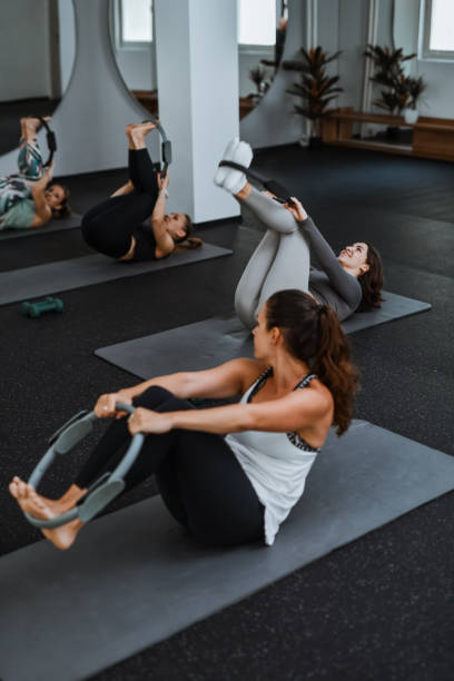 istock Female Athletes Struggling To Perform Pilates Ring Exercises 2161798865