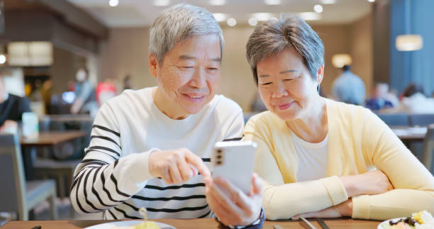 elder couple use smart phone