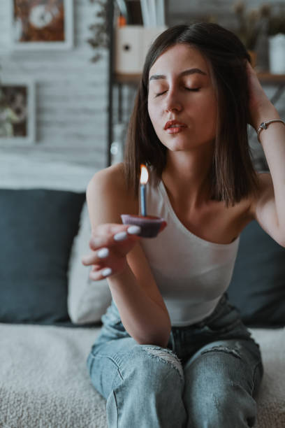 istock Female Getting Ready To Make A Birthday Wish With Her Cupcake Candle 2161800170