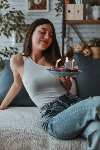 istock Relaxed Female Getting Ready To Eat Birthday Cupcakes 2161800236