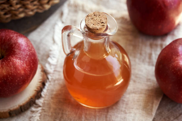 istock Apple cider vinegar in a glass bottle with fresh red apples 2161802110