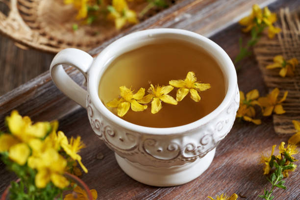 istock St. John's wort or Hypericum flower tea in a white ceramic vintage cup 2161802292
