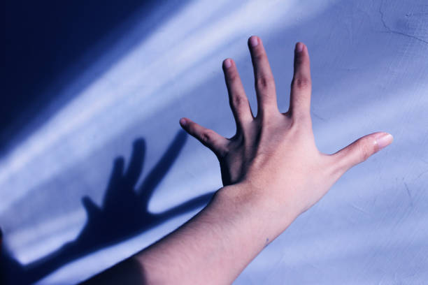 istock closeup hand reaching a wall, beautiful sunlight 2161802868