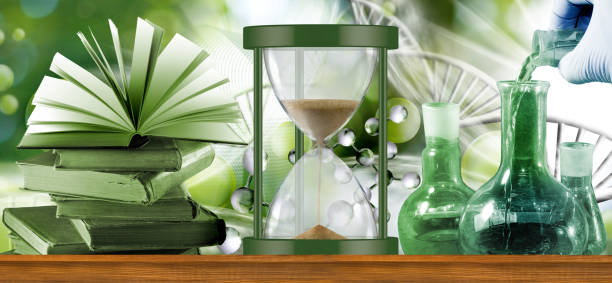 A still life image featuring an hourglass, books, and laboratory beakers, symbolizing the interplay of science, literature, and the pursuit of knowledge.