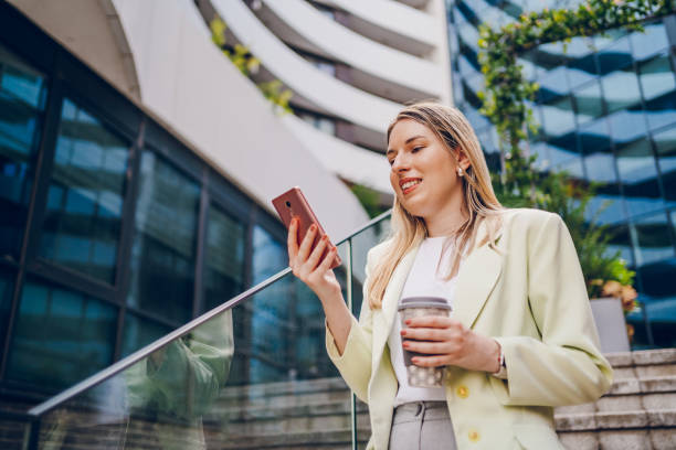 istock Business woman using phone and going to work 2161805587