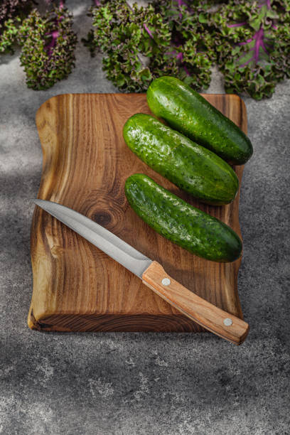 istock Knife On Kitchen Wood And Cucumbers. 2161805709