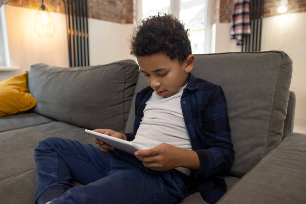 istock African American boy playing with digital tablet 2161808644
