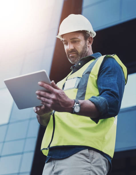 istock Man, construction and architect or tablet outside, building inspection and online plan for property development. Professional, architecture and digital blueprint on app , engineering design and tech 2161812758