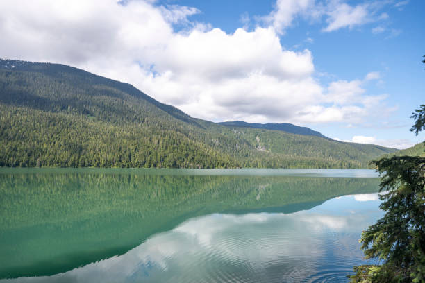 istock Reflection of mountains in lake and lofty clouds 2161817488