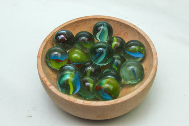 Marbles in wooden container close up