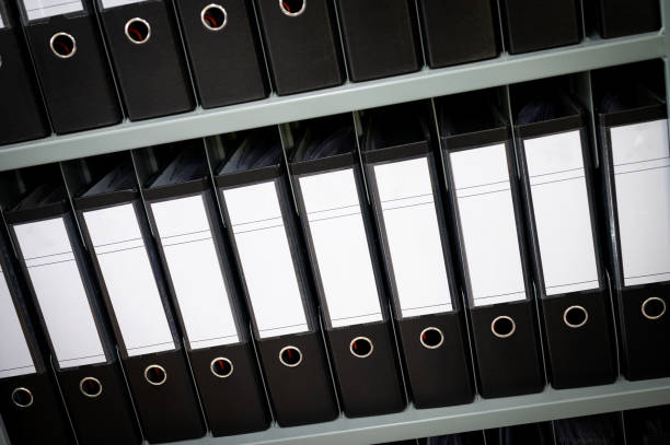 istock Many documents organized in row on office shelf, Folders binders. 2161822068