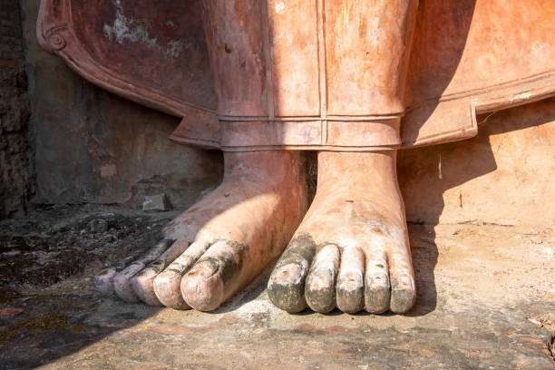 Buddha's big foot in Wat Mahathat. The temple located in Sukhothai historical park and its name translates to 'temple of the great relic'. The temple was founded by Sri Indraditya, between 1292 and 1347 as the main temple of the city as well as the Sukhothai Kingdom.