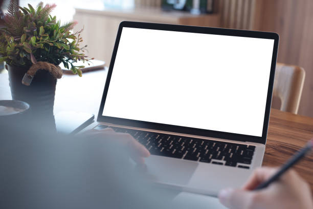 istock Mockup blank screen laptop computer. Business woman working on laptop computer at home office, planning work project on paper notebook. Student studying online course via laptop, template for online marketing 2161834056