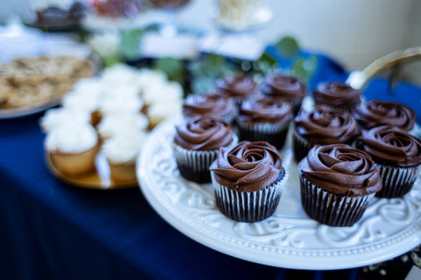 Beautiful colorful elegant wedding formal event dessert table full of yummy snacks and treats.