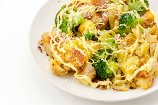 Baked potatoes and broccoli with mayonnaise dressing