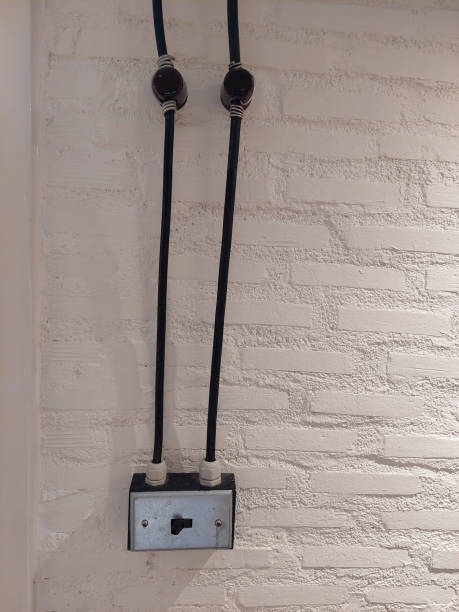 istock Vintage Electrical Switch with Exposed Wiring on Wall 2161839469
