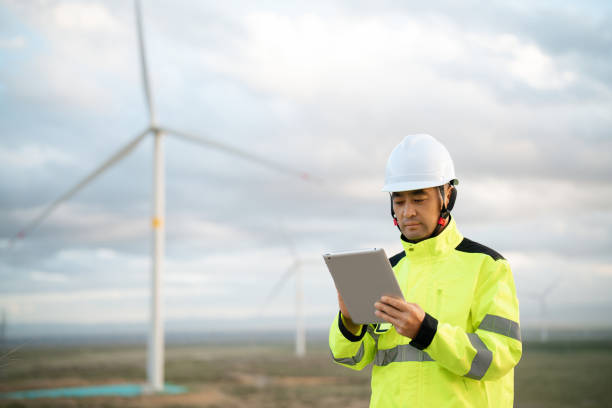 istock Middle-aged male electricity technician working at wind power station 2161840050