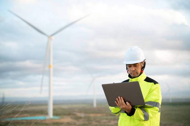 istock Middle-aged male electricity technician working at wind power station 2161840086