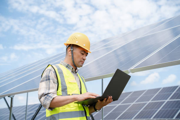 istock Middle aged male electricity technician working at solar power station 2161840807