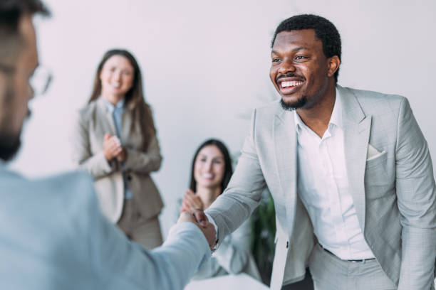 istock Businesspeople shaking hands across the table. 2161842564