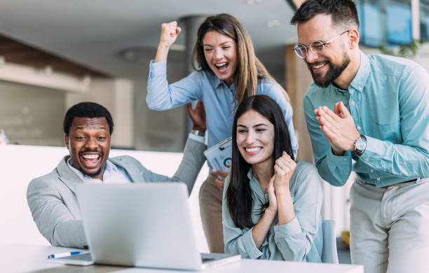 istock Cheerful entrepreneurs celebrating success in the office. 2161842593