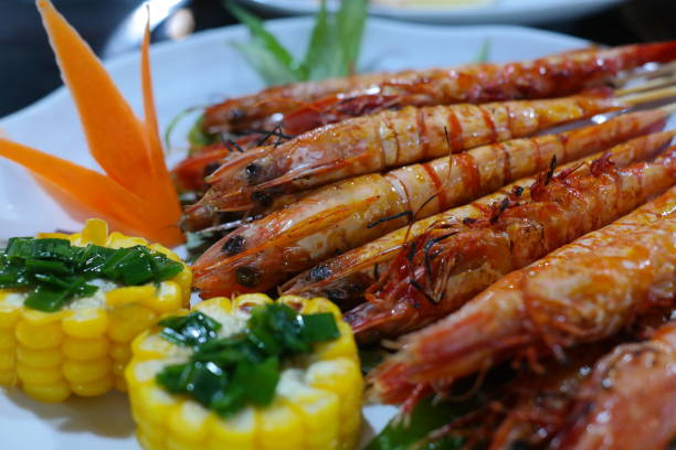 istock Grilled tiger prawns with sweet corn on the cob 2161844831