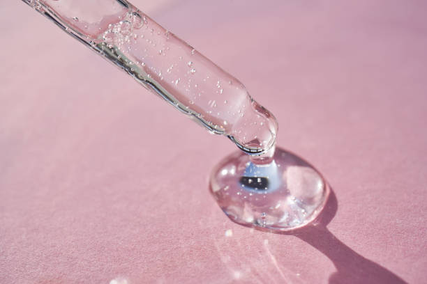 istock Pipette with serum shimmering in the sun on a pink background. 2161850134