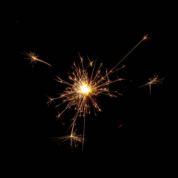 istock burning sparkler with flying sparks on a dark background 2161850336