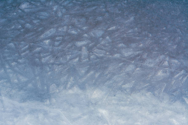 Cracked ice on a frozen lake, view from the top. Mouse background. Selective focus.