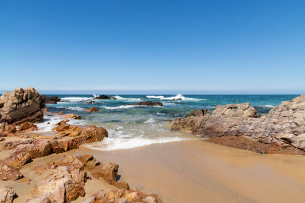 istock surf and rock on the beach 2161852295