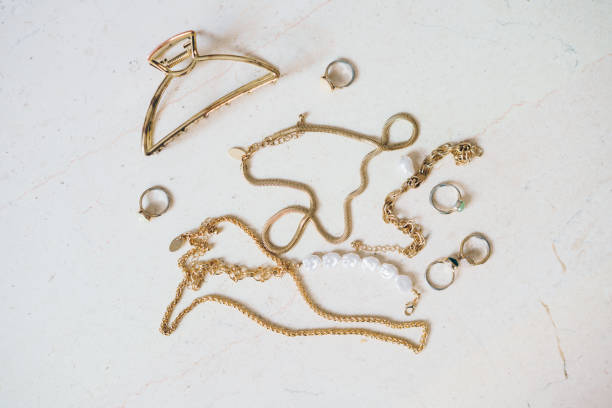 istock Gold jewellery on a marble surface 2161852799