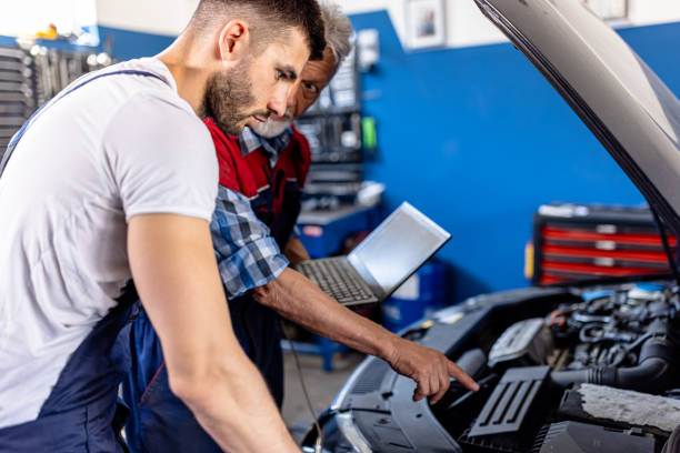 istock An Older Car Mechanic Man and Young Colleagues are Analyzing Car Problems with a Laptop. 2161853694